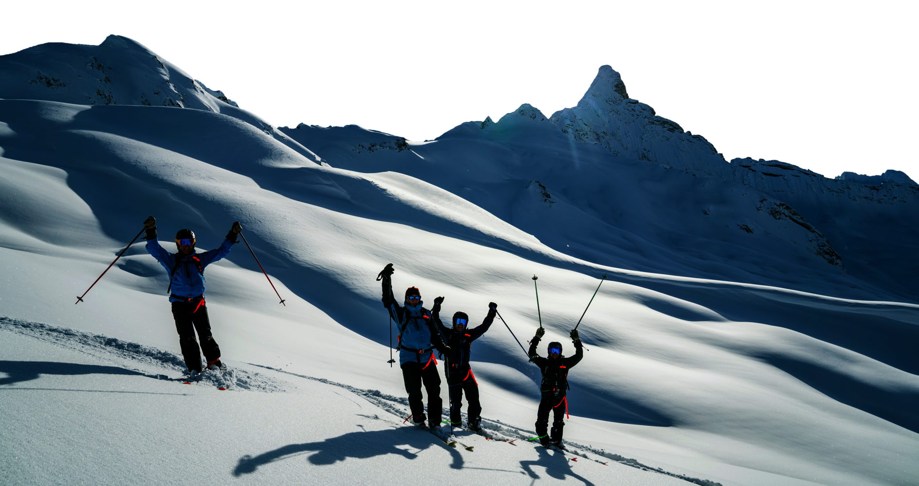 skiers in mountains stopped with poles in air