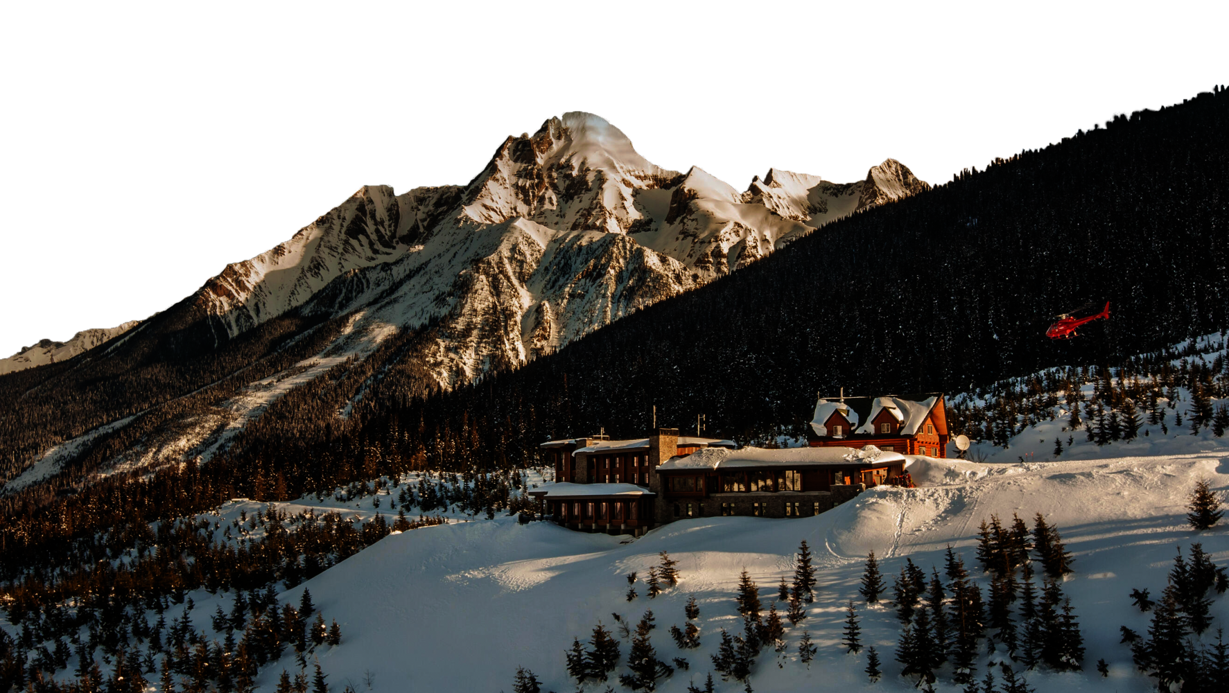 mica lodge with red helicopter and mountain in background